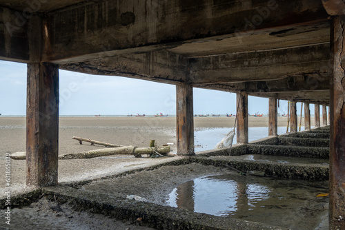 Under the sea bridge where the water is receding.