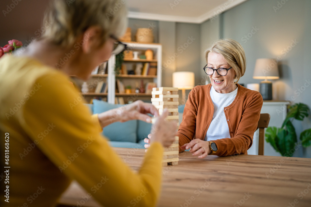 two senior women friends or sisters play leisure board game at home two senior women friends or sisters play leisure board game at home