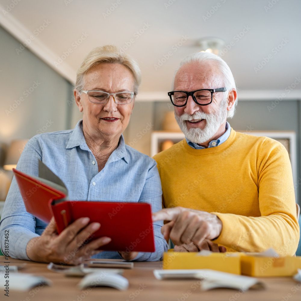 Senior couple man and woman husband wife looking family photos album Senior couple man and woman husband wife looking family photos album