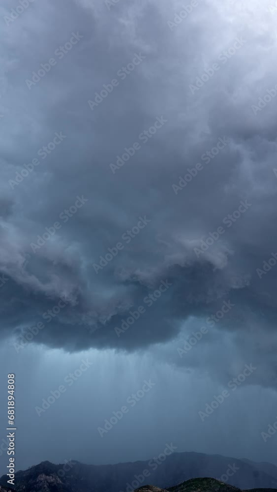Vertical Timelapse of dramatic storm rolling over the mountains in Utah over Nebo during summer monsoon. Vertical Timelapse of dramatic storm rolling over the mountains in Utah over Nebo during summer monsoon.