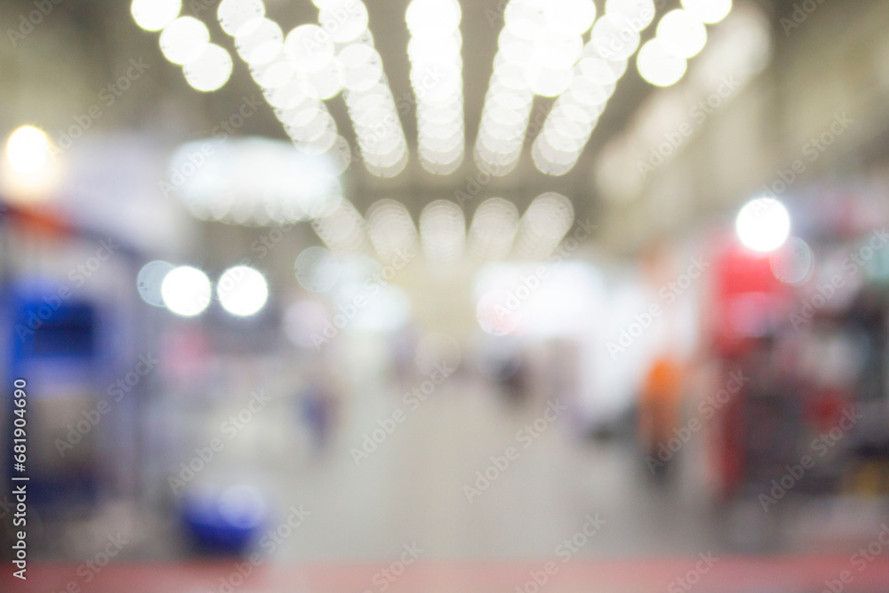 Fototapeta premium Large high building premises with people walking inside. Blurred background.