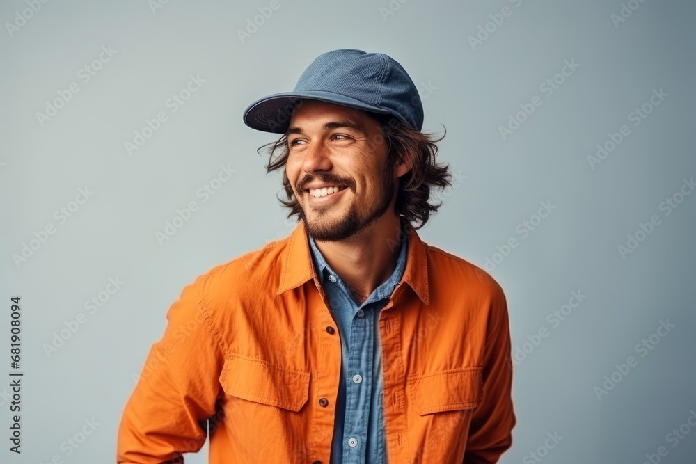 Portrait of a handsome young man wearing a cap and orange shirt Portrait of a handsome young man wearing a cap and orange shirt