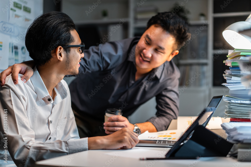 Asian handsome two businessman using laptop computer working in office. Asian handsome two businessman using laptop computer working in office.