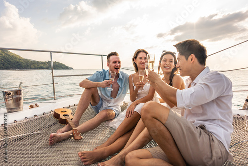 Group of diverse friends drink champagne while having a party in yacht.  © Kawee