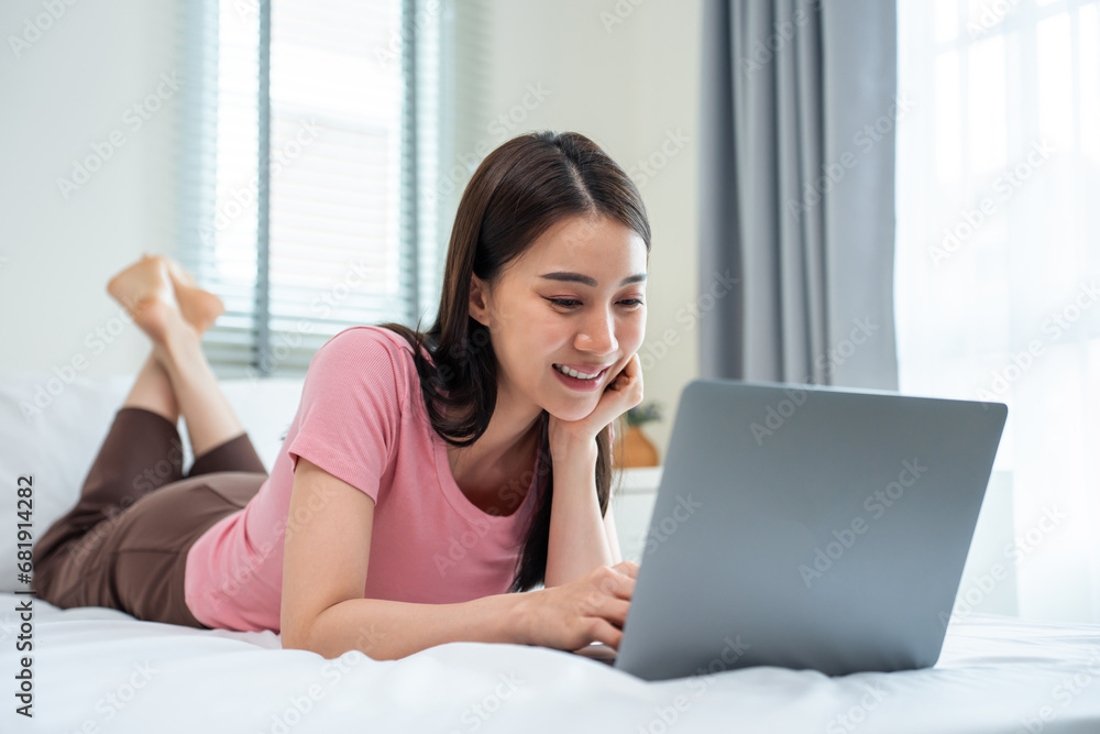 Asian attractive woman using laptop chat on bed at home in the morning. Asian attractive woman using laptop chat on bed at home in the morning.
