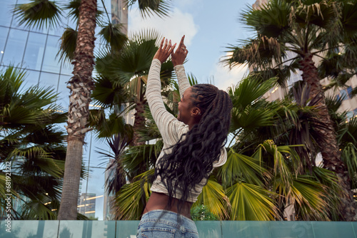 Canvas Print Portrait of Young Black Woman Playfully Enjoying Her Time at the Park in the Cit