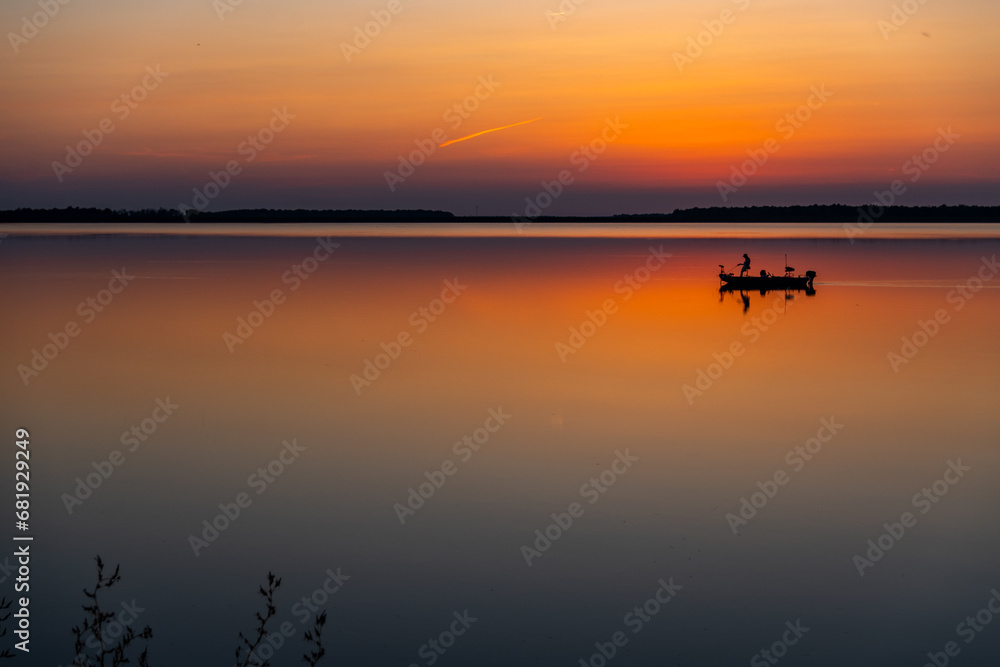 Fishing Boat on Colorful Reflective Lake in Evening Twilight