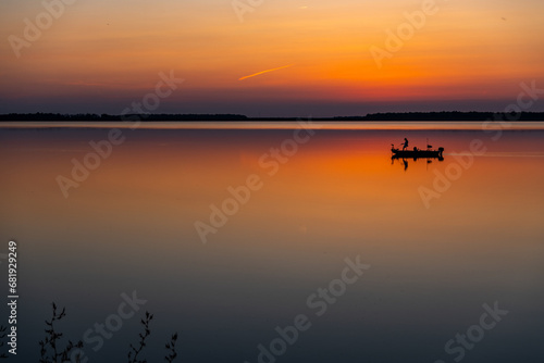 Fishing Boat on Colorful Reflective Lake in Evening Twilight