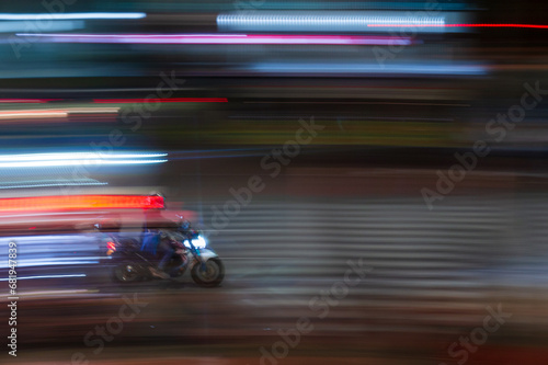 portrait shot of motorcycle moving through traffic