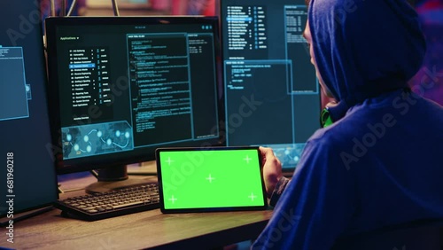 Hackers doing computer sabotage using encryption trojan ransomware on green screen tablet. Cybercriminals use mockup device to demand ransom money from victims in exchange for access to their data photo