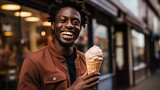 A black man holding an ice cream cone.