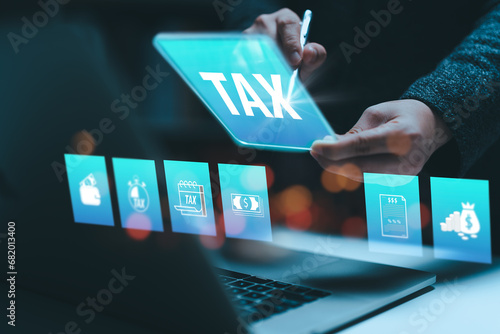 Businesswoman using the laptop to fill in the income tax online return form for payment. Financial research,government taxes and calculation tax return concept. Tax and Vat concept