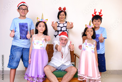 Happy expression of grandpa and grandma having Christmas photo session with their grandchildren