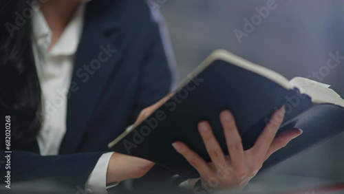 Lawyer reading law book and writing contract and matters of law and contract for clients prepare for the trial. photo