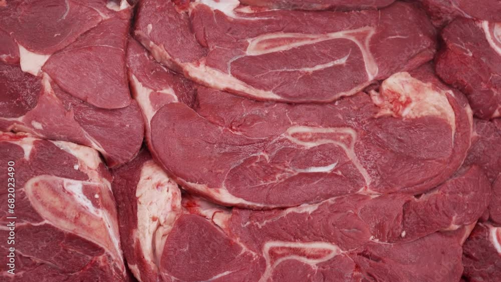 Large pieces of chilled raw meat lie on the shop window. Large pieces of chilled raw meat lie on the shop window.