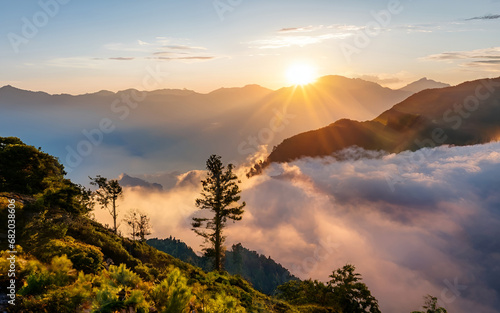 Ethereal Majesty, A Mesmerizing Sunrise Blankets Misty Mountain Peaks in Golden Splendor