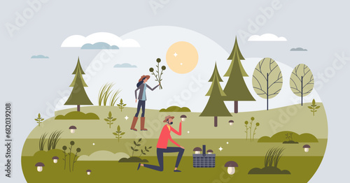 Foraging and wildcrafting as outdoor activity in forest tiny person concept. Collect natural resources as mushrooms, herbs, wild flowers and berries vector illustration. Organic bio food harvest. photo