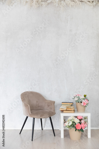 One Office Chair Coffee Table With Flowers In White Room Interior photo