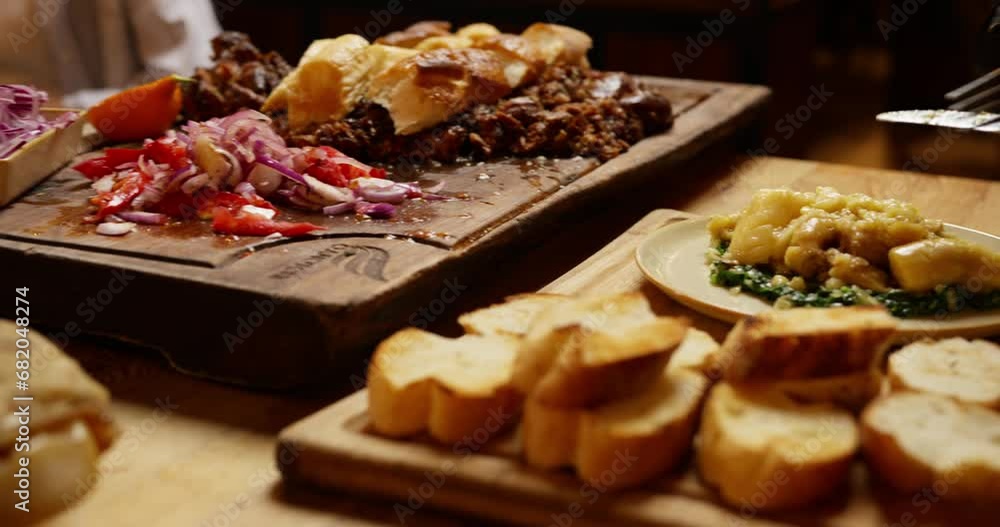 The waiter cuts the finished meat and runs the table in the restaurant The waiter cuts the finished meat and runs the table in the restaurant