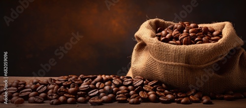 The brown hessian bag with a coffee-coloured background texture contained fresh coffee beans harvested from an agriculture field, where the aromatic grains were carefully roasted to create a delicious