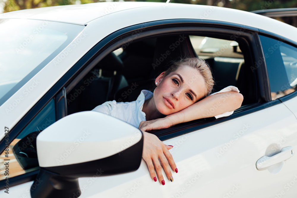 Blonde woman driving a car driver on the road