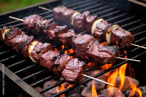 close-up of beef skewers on backyard barbecue