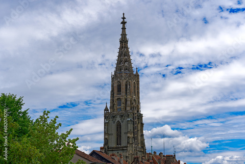 Fototapeta Naklejka Na Ścianę i Meble -  cenic view of church tower of Minster Church at the old town of Swiss City of Bern on a cloudy summer day. Photo taken July 1st, 2023, Bern, Switzerland.