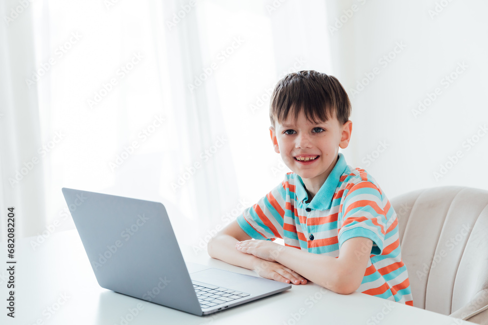 Boy doing learning task at school on computer Boy doing learning task at school on computer