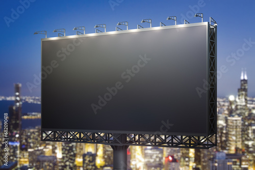 Blank black horizontal billboard on skyline background at evening, perspective view. Mock up, advertising concept