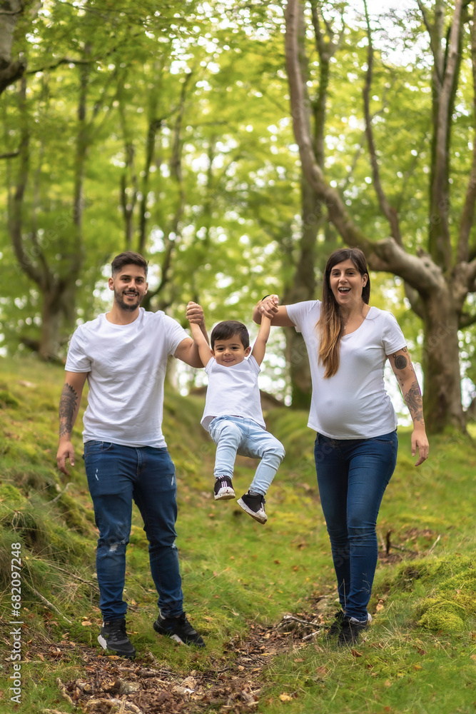Family playing while walking along a forest