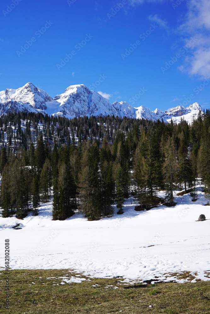 Natural landscape of snowy mountain hill with cloudy blue sky
