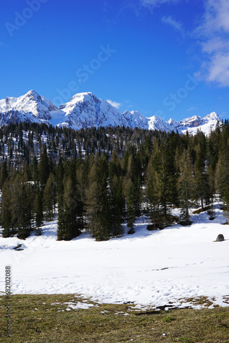Natural landscape of snowy mountain hill with cloudy blue sky