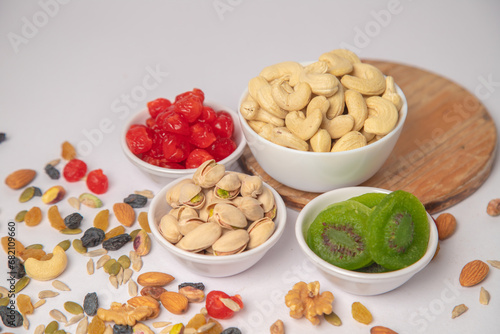 Mixed nuts on white bowl with white background, mixed dry fruits and nuts on white bowl with white background