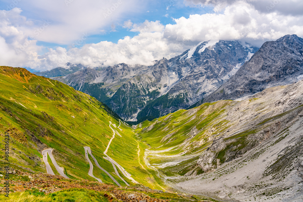 Stelvio pass serpentines with Ortler mountain on background. Asphalt road high in the Italian Alps, Italy