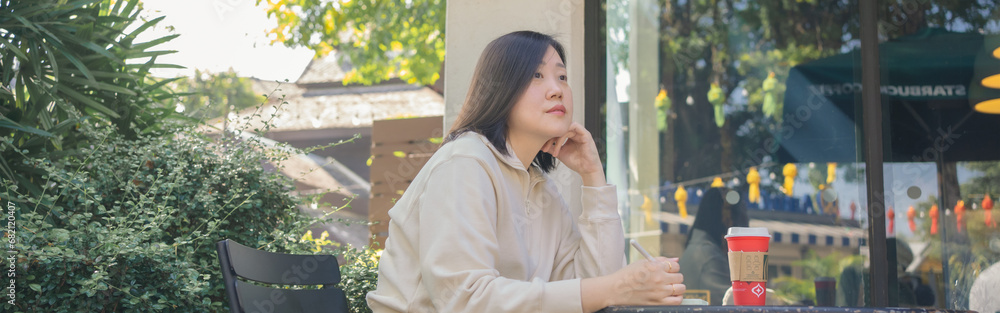 web banner digital nomad concept asian freelancer woman use laptop to work at outdoor of coffeeshop web banner digital nomad concept asian freelancer woman use laptop to work at outdoor of coffeeshop