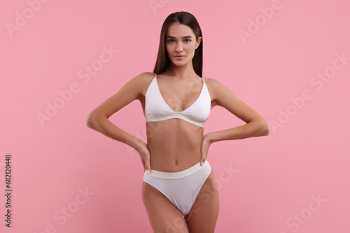 Young woman in stylish white bikini on pink background