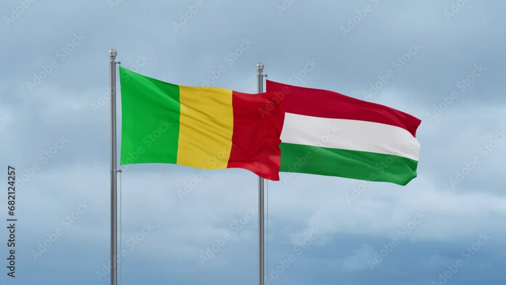 Hungary flag and Mali flag waving together on cloudy sky, endless seamless loop, two country relations concept Hungary flag and Mali flag waving together on cloudy sky, endless seamless loop, two country relations concept