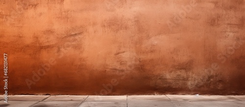 The brown wall on the street had a fascinating texture with a background texture that added depth and richness to its color.