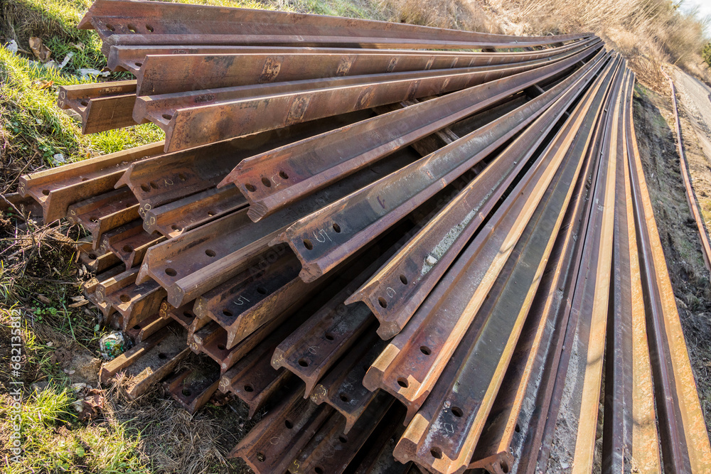 stacked steel rails prepared for the installation of a new railway line stacked steel rails prepared for the installation of a new railway line