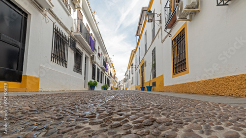 Narrow alley with typical Andalusian white houses, Córdoba Spain