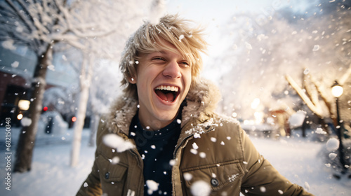Close up portrait of blond man happily screaming into falling snow