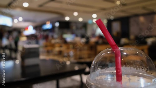Closer capture of the Red Straw in a Plastic Disposable Cup in a restaurant in Bangkok, Thailand photo