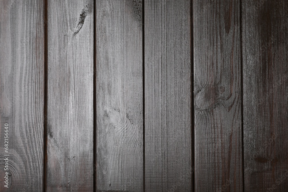 Naklejka premium Texture of dark wooden surface as background, top view