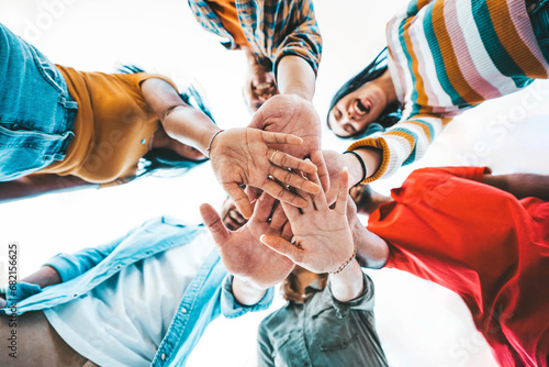 Community of millennial people stacking hands together - Multiracial college students putting their hands on top of each other - Human relationship, social, community and team building concept