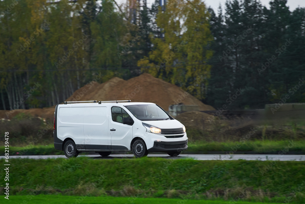 On the Delivery Route. Commercial Van Close-Up on the Road. Logistics branding. Commercial van on the road. Final destination shipping truck mock-up. On the Delivery Route. Commercial Van Close-Up on the Road. Logistics branding. Commercial van on the road. Final destination shipping truck mock-up.
