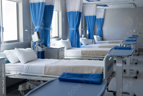 Close up of row of beds in sunny hospital room photo