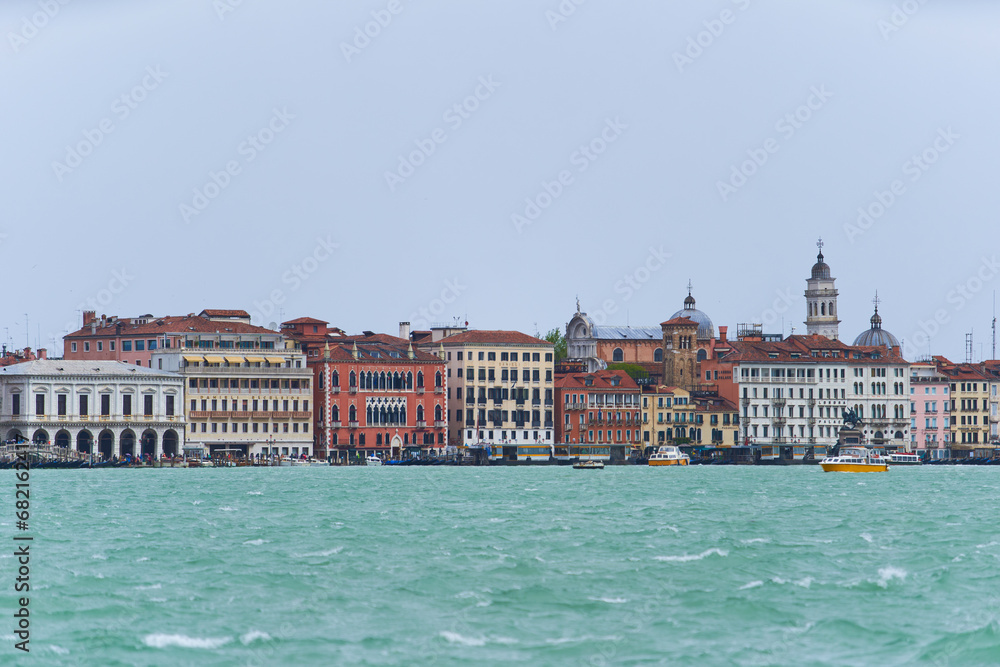 Panorama of Venetian canal waterfront. Colorful houses on the embankment of Guidecca channel. Venice - 5 May, 2019