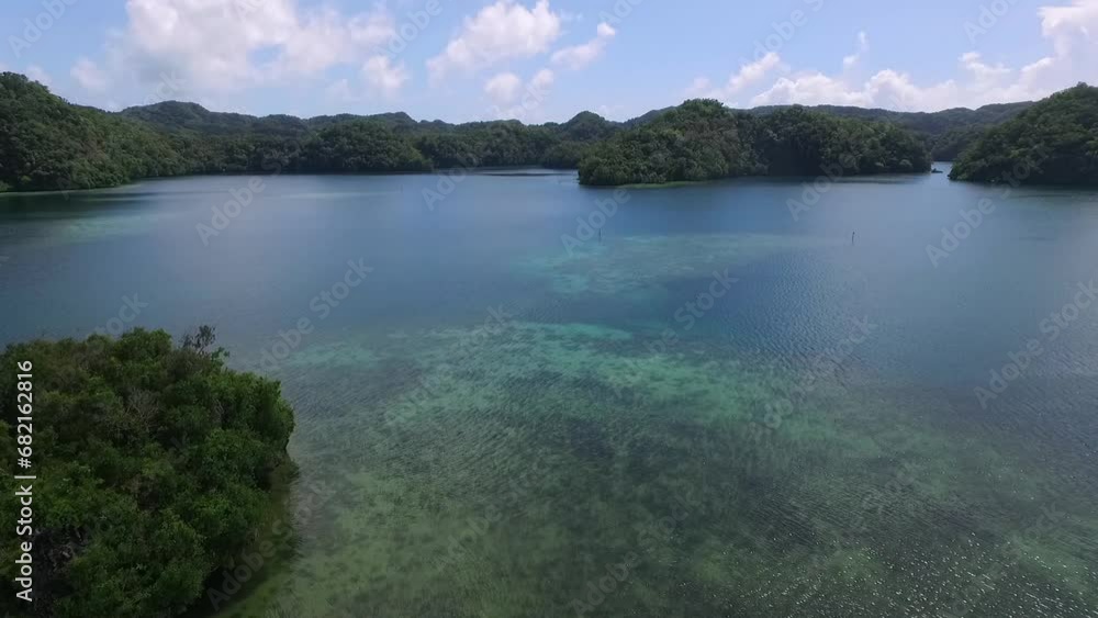 Aerial View Of Koror Island. Many Green Islets. Palau Seascape With Colorful Coral Reefs And Tropical Lagoons in Background Aerial View Of Koror Island. Many Green Islets. Palau Seascape With Colorful Coral Reefs And Tropical Lagoons in Background