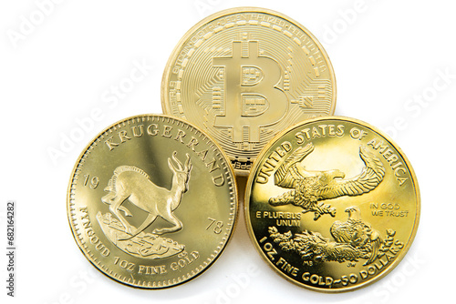 Krugerrand, United States gold eagle 50 dollar coin, and a bitcoin. photo