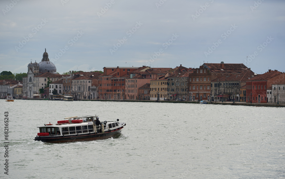 Obraz premium Venetian water bus crusing in canal between Dorsoduro and Guidecca. Venice - 6 May, 2019